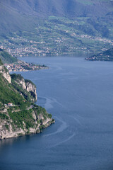 Landscape with a view of a beautiful rugged coast of Lake Iseo and small villages overlooking the lake and Montisola on the right