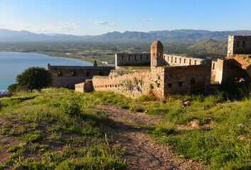 Palamidi Castle walls built high on the crest of a hill above the old Nafplio city. View of ruins...