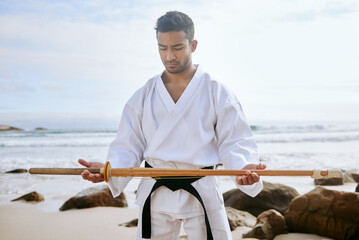 Warriors are always ready for anything. Shot of a young martial artist practising karate with a...