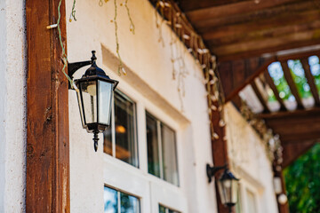 Fototapeta na wymiar Retro lantern on the porch of the house. Lantern in a classic style