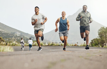No racing, just friends motivating each other. Shot of three men out for a run on a mountain road.