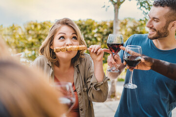 Fun Outdoor Picnic with Friends - Curvy woman uses a skewer as a mustache, amusing her diverse...