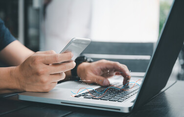 businessman gathering data, turning it to statistics, and developing a plan gathering information and producing graphs visually on a computer, laptop, and smart mobile device