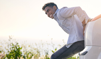 Maybe a push will help.... Full length shot of a handdsome young man pushing his car after suffering a vehicle breakdown.