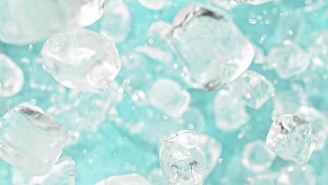 Super slow motion of rotating ice cubes, top view shot. Filmed on high speed cinema camera, 1000 fps, placed on high speed cine bot, following the object. Speed ramp effect.