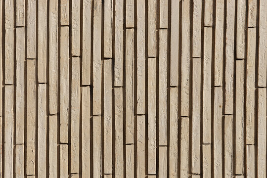 Wall of beige vertical clinker bricks