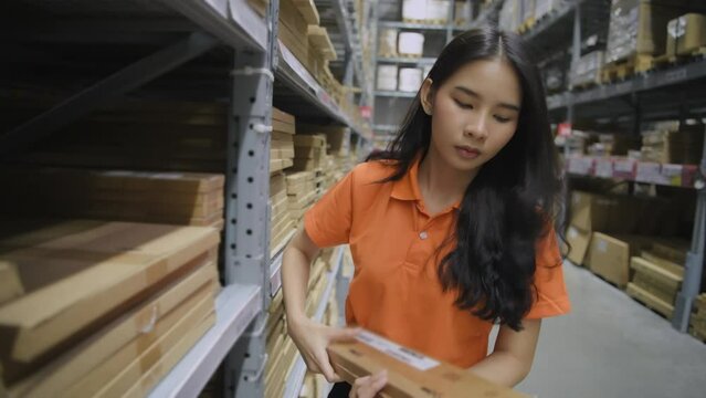 Shopping concept of 4k Resolution. Asian female employees sorting goods in a warehouse.