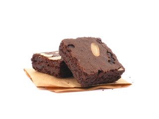 Brownies on paper isolated white background. Chocolate brownie with sliced almond nuts toppings. Chocolate Brownie pieces. selective focus.