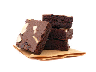 Brownies on paper isolated white background. Chocolate brownie with sliced almond nuts toppings. Chocolate Brownie pieces. selective focus.