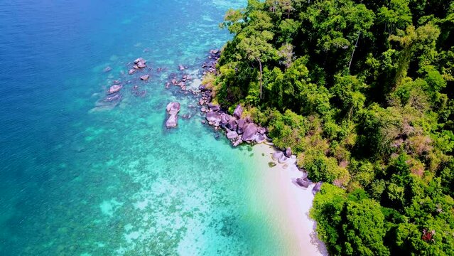 couple with a kayak on a small Island in front of the Island of Ko Lipe Thailand, Kla Island
