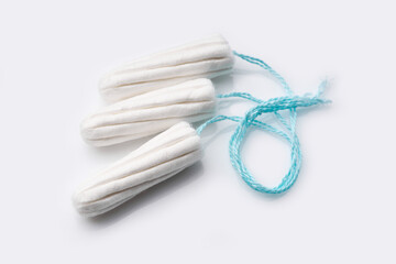 Medical female tampon on a pink background. Hygienic white tampon for women. Cotton swab. Menstruation, means of protection. Tampons on a red background. 