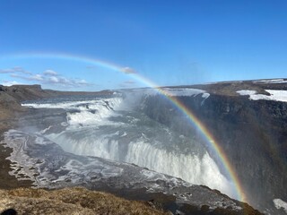 A rainbow over a waterfall in Iceland