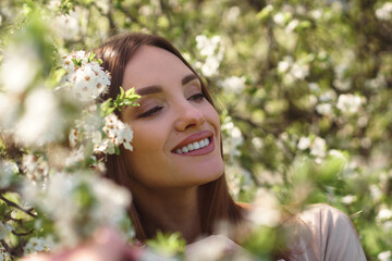 beautiful girl posing in cherry blossom garden