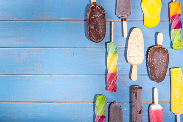Various ice cream popsicle on high-colored yellow background, summer sweets, dessert, vacation and...