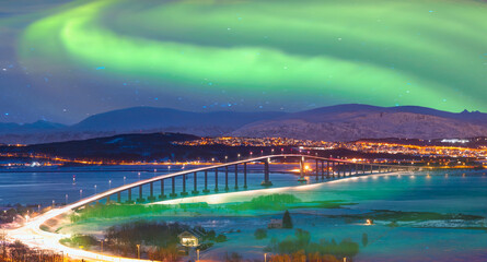 Aurora borealis or Northern lights in the sky over Tromso with Sandnessundet Bridge - Tromso, Norway