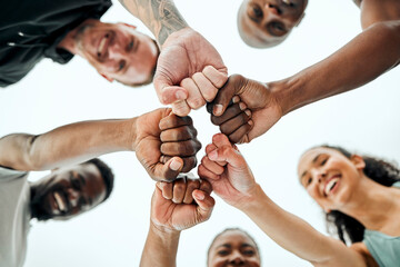 Believe in yourself and you could do it. Shot of a group of friends fist bumping one another before...