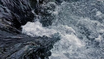 Close up pure mountain water fast flows downstream over rocks beautiful scene