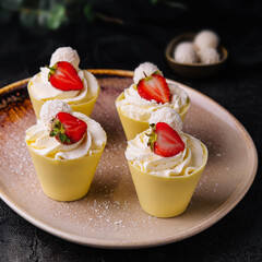 Beautiful pavlova cakes with strawberries and raffaello