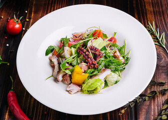 arugula salad with octopus on white plate