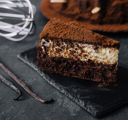 Vanilla and chocolate cake on black board