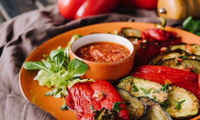 Grilled colorful vegetables, aubergines, zucchini, pepper with spice and green basil