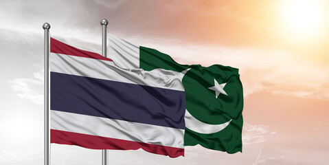 Flags of Pakistan and Thailand friendship flag waving on the sky with beautiful sky.