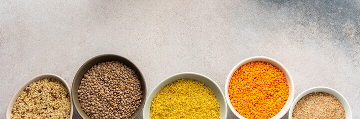Various grain cereals in bowls banner, top view