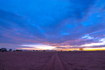 Fototapeta na wymiar Blue, pink and yellow clouds after sunset in the desert