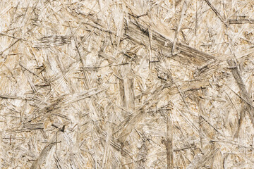 OSB board texture. Brown wooden background. Simple pressed chipboard pattern. Chip board background. Brown wood texture.