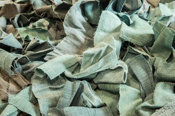 Pile of fabric scraps closeup as textile background