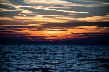 Horizon Sunset on the wavy Ocean with clouds, in Umag, Croatia