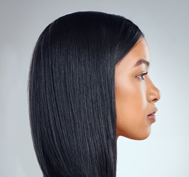 Sleek on fleek. Studio shot of an attractive young woman posing against a grey background.