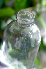 closeup clear glass bottle isolated on blurred background