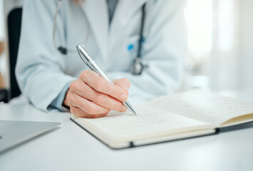 The research never ends in the medical field. Cropped shot of an unrecognisable doctor sitting alone in her clinic and writing notes.