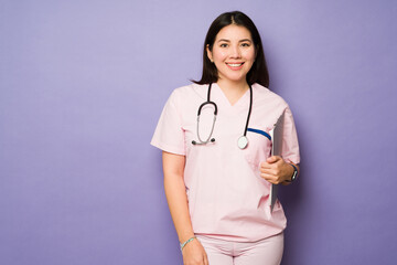 Beautiful caucasian doctor with scrubs looking happy