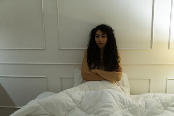 Stressed woman thinking about her problems before sleeping