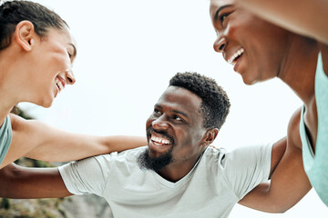 Fototapeta premium Making the most of this beautiful day. Shot of a group of friends huddled up before a workout.