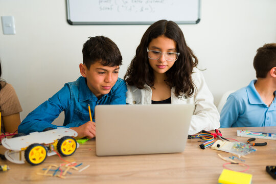 Smart teen friend students coding together in school