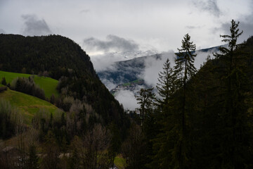 clouds over the mountains, Italian alpine village