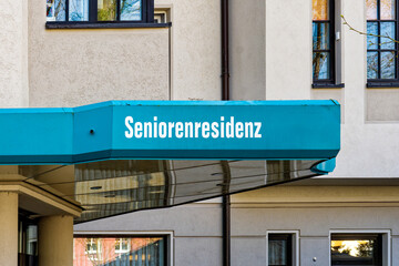 Fototapeta na wymiar Sign on the wall of a nursing and retirement home. The text Seniorenresidenz is German for senior residence.