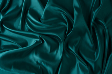 Silk fabric, abstract wavy green satin fabric background.