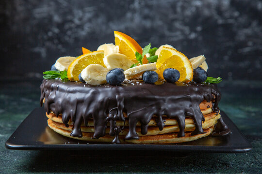 front view delicious chocolate cake with fresh fruits on dark background sugar biscuit cake pie sweet dough