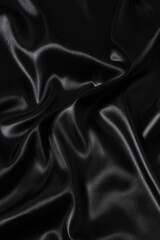 Silk fabric, abstract wavy black satin fabric background.