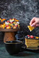 front view delicious fruit cake with cup of tea dark background tea pie dessert sweet cake sugar dough