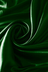 Obraz premium Background green twisted silk fabric,abstract texture satin fabric.