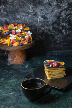 front view delicious fruit cake with cup of tea dark background tea pie dough dessert sweet biscuits cake sugar