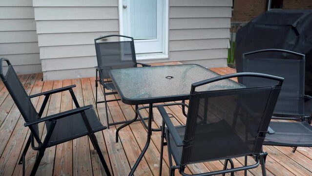 black patio furniture on brown deck