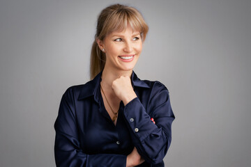 Businesswoman with blond hair over grey background