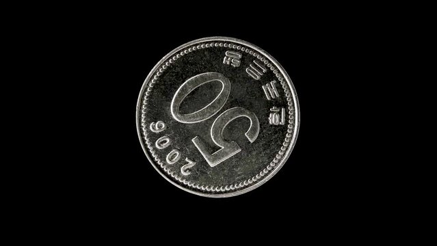 Reverse of Korea coin 50 won 2006 isolated in black background. 4k video