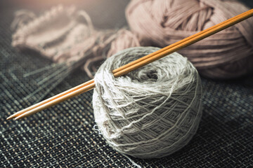Closeup of woolen threads and knitting needles